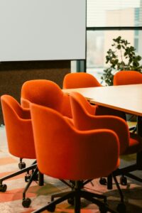 Orange chairs around a conference room table